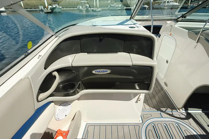 Slide: The Image of 2000 Four Winns 260 Horizon boat interior with dashboard and seating area. - 25