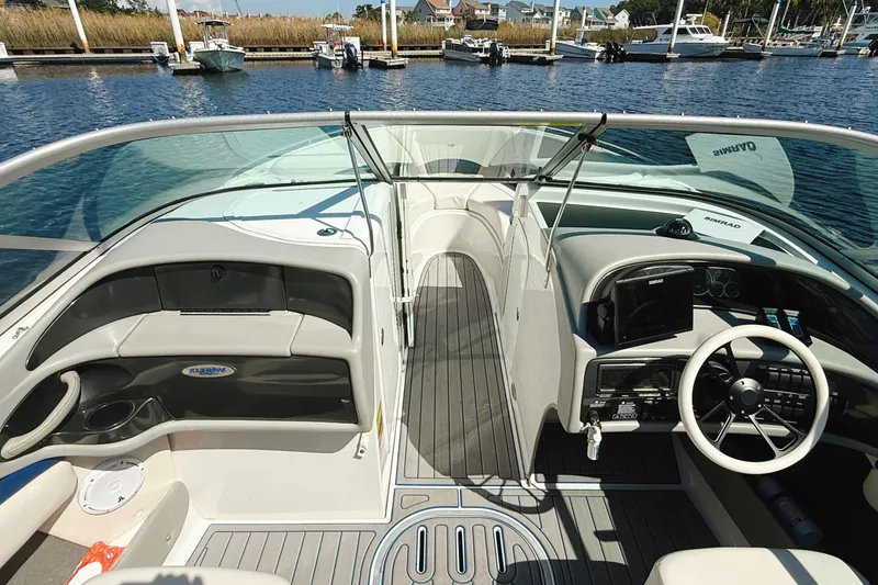 Slide: The Image of 2000 Four Winns 260 Horizon boat interior with steering wheel and dashboard, docked at marina. - 26