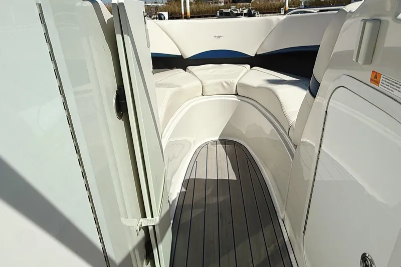 Slide: The Image of 2000 Four Winns 260 Horizon boat interior with cushioned seating and wooden flooring. - 29