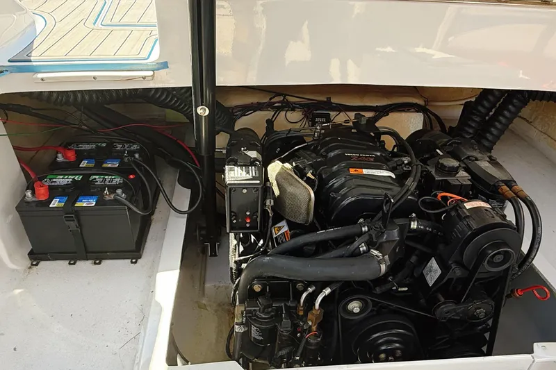 Slide: The Image of Engine compartment of a 2000 Four Winns 260 Horizon boat, showing batteries and engine components. - 30