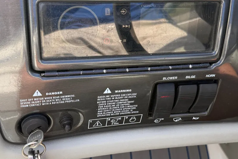 Slide: The Image of Control panel of a 2000 Four Winns 260 Horizon boat with safety warnings and switches. - 8
