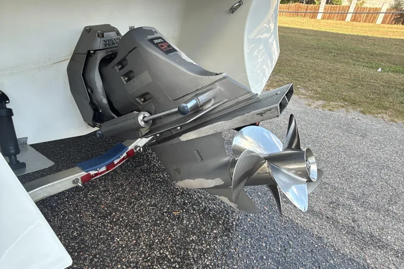 Slide: The Image of Volvo Penta outdrive on 2000 Four Winns 260 Horizon boat, parked on asphalt. - 9