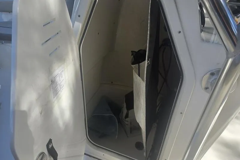 Slide: The Image of 2023 Key West 203 FS boat storage compartment with open door. - 17