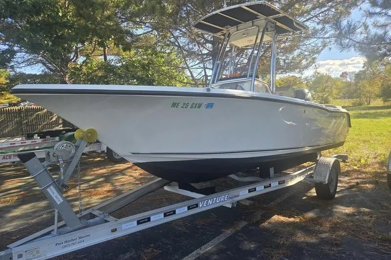Slide: The Image of 2023 Key West 203 FS boat on trailer, parked outdoors under trees. - 4