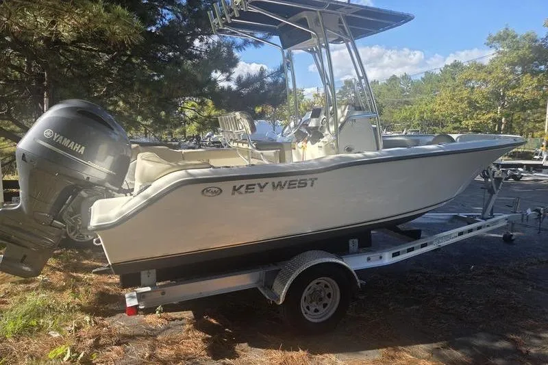 Slide: The Image of 2023 Key West 203 FS boat on trailer with Yamaha engine, parked outdoors. - 7