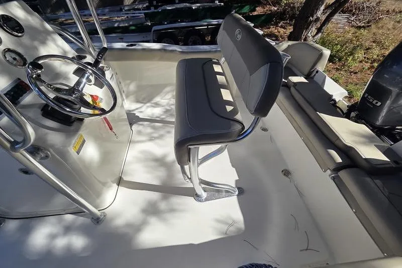 Slide: The Image of 2023 Key West 203 FS boat interior with steering wheel and seating. - 8