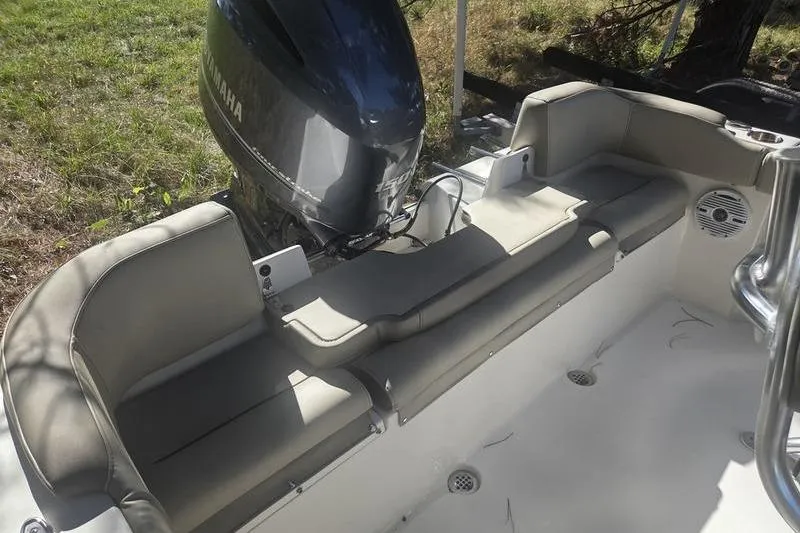 Slide: The Image of 2023 Key West 203 FS boat interior with Yamaha engine, featuring cushioned seating. - 9