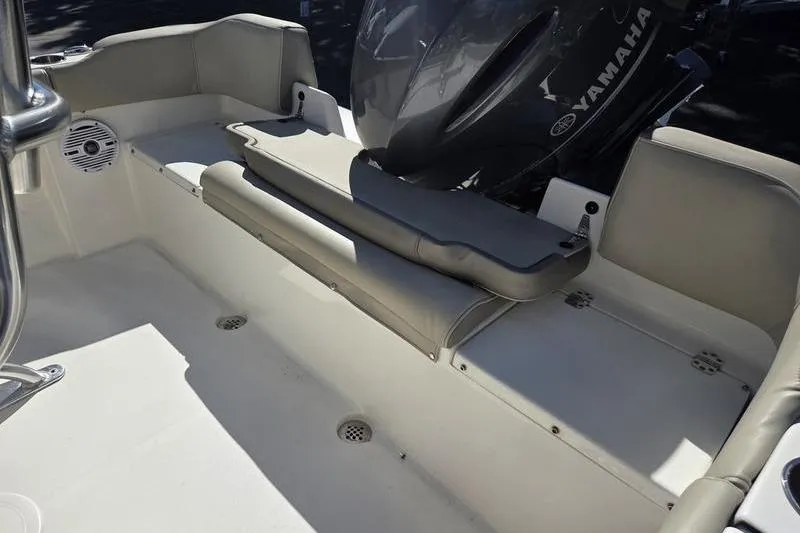 Slide: The Image of 2023 Key West 203 FS boat interior with Yamaha engine, featuring cushioned seating. - 15