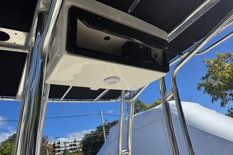 Slide: The Image of 2023 Key West 203 FS boat T-top with electronics box under clear blue sky. - 16