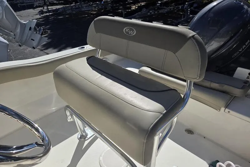 Slide: The Image of 2023 Key West 203 FS boat seat with KW logo and steering wheel. - 18