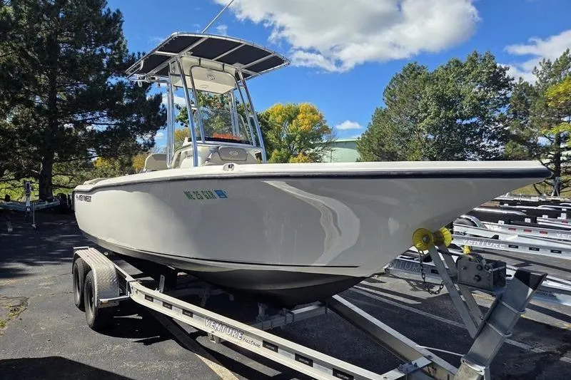 The Image of 2023 Key West 203 FS boat on trailer, parked outdoors under a clear sky. - 2
