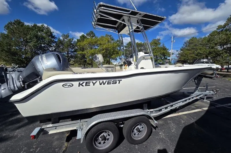 Slide: The Image of 2023 Key West 203 FS boat on trailer under clear blue sky. - 4
