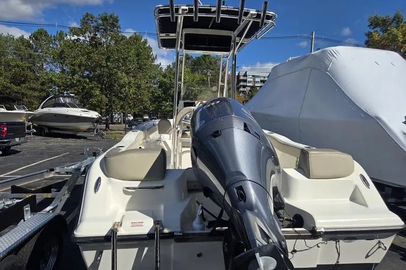 Slide: The Image of 2023 Key West 203 FS boat with outboard motor, parked on a trailer in a marina. - 5