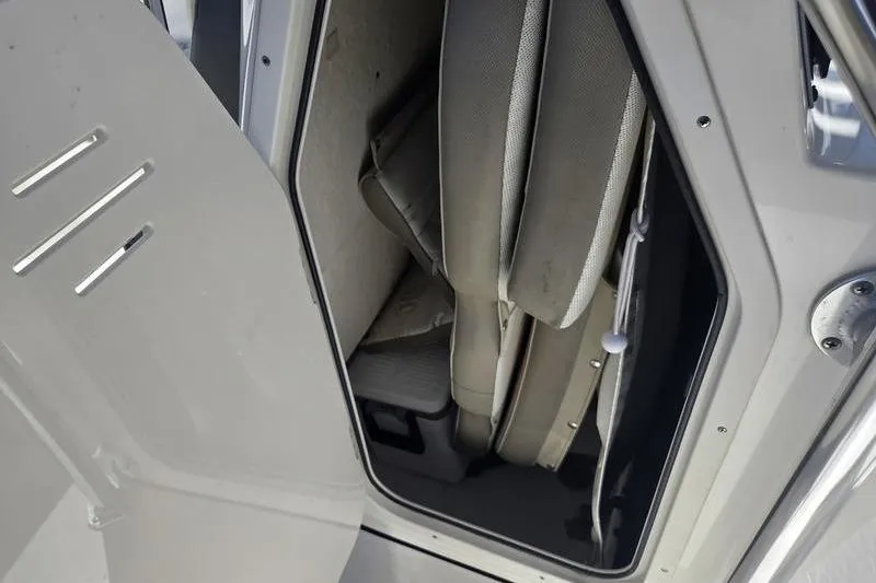 Slide: The Image of 2023 Key West 203 FS boat storage compartment with cushioned seats. - 7