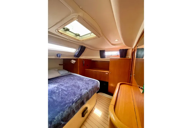 Slide: The Image of Cozy cabin interior of 2000 Moody 42 CC yacht with wood finish and skylight. - 12