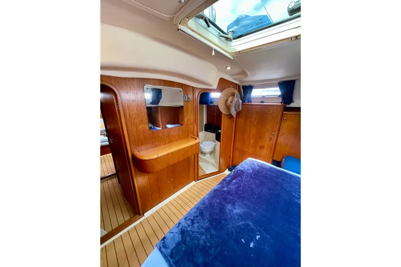 Slide: The Image of Interior of 2000 Moody 42 CC yacht with wooden finish and skylight. - 13