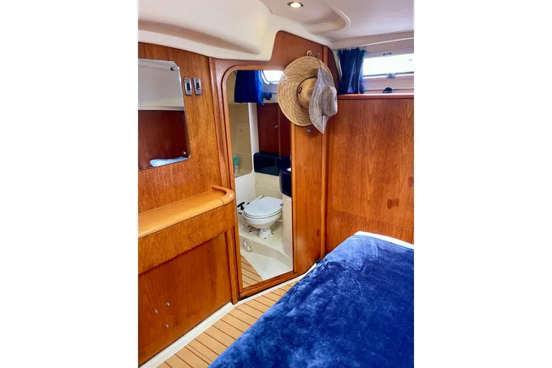Slide: The Image of Cozy interior of 2000 Moody 42 CC yacht with wooden finish and bathroom view. - 14