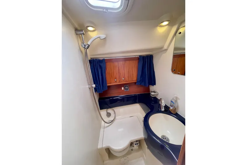 Slide: The Image of Moody 42 CC 2000 yacht bathroom with shower, sink, and wooden cabinets. - 20