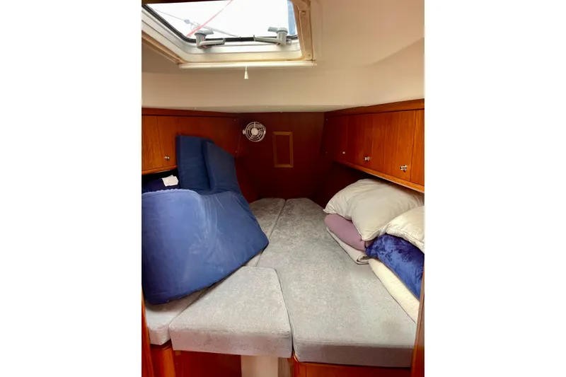 Slide: The Image of Cozy cabin interior of 2000 Moody 42 CC sailboat with skylight and cushions. - 21