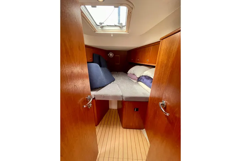 Slide: The Image of Cozy cabin interior of 2000 Moody 42 CC sailboat with wooden finish and skylight. - 22