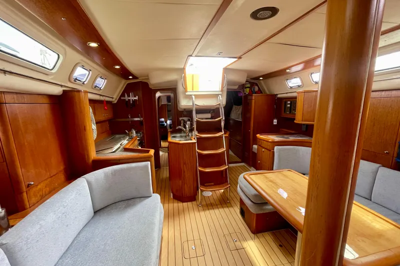 Slide: The Image of Luxurious interior of 2000 Moody 42 CC sailboat with wooden finishes and cozy seating. - 23