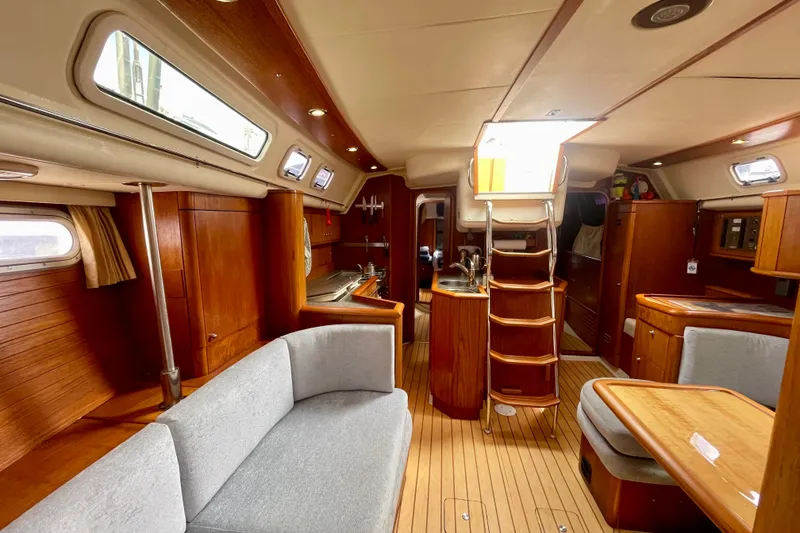 Slide: The Image of Interior of 2000 Moody 42 CC sailboat with wooden furnishings and cozy seating. - 24