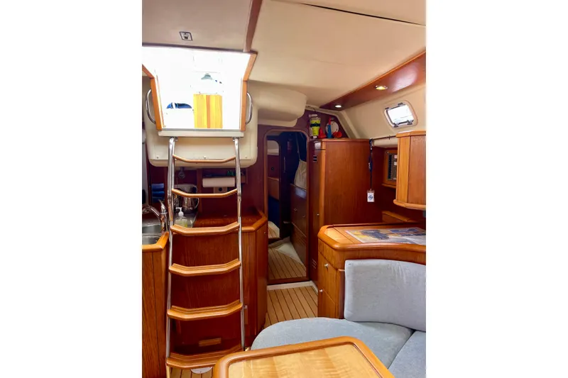 Slide: The Image of Interior of 2000 Moody 42 CC sailboat with wooden finish and cozy seating area. - 29