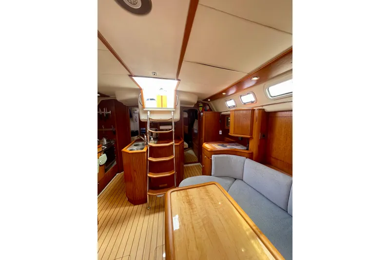 Slide: The Image of Interior of 2000 Moody 42 CC yacht with wooden finish and cozy seating area. - 30