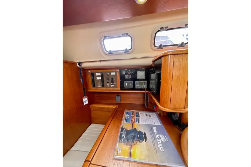Slide: The Image of Interior of 2000 Moody 42 CC sailboat with navigation equipment and wooden finish. - 37