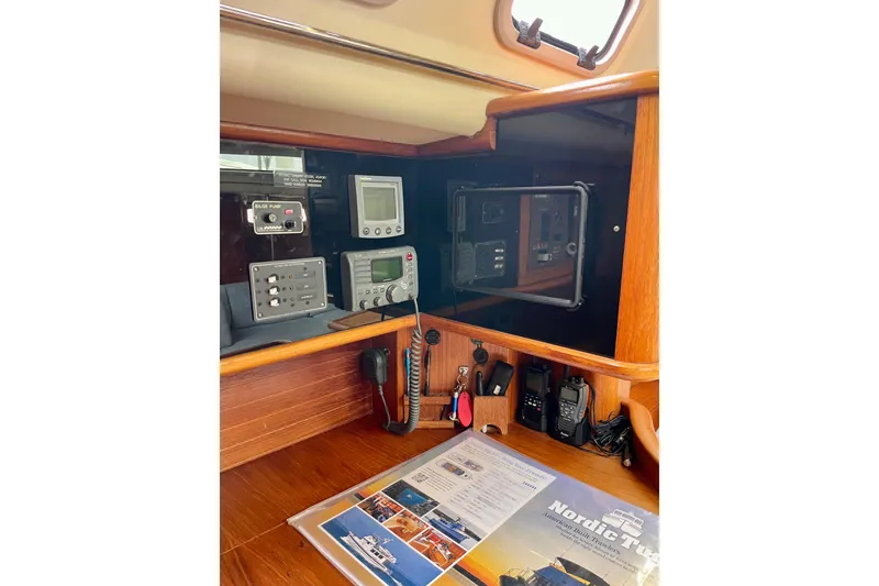 Slide: The Image of Navigation equipment and controls inside a 2000 Moody 42 CC sailboat cabin. - 38