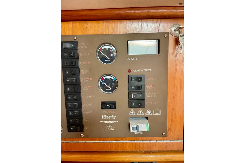 Slide: The Image of Control panel of a 2000 Moody 42 CC yacht with switches and gauges. - 40