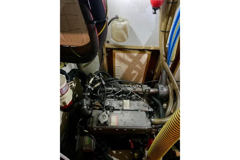 Slide: The Image of Engine compartment of a 2000 Moody 42 CC sailboat, featuring hoses and components. - 45