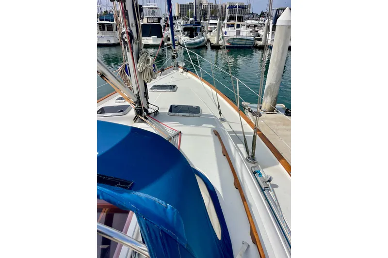 Slide: The Image of Sailboat Moody 42 CC, 2000 model, docked in marina with blue canopy. - 57