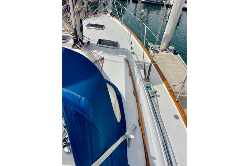 Slide: The Image of Deck view of a 2000 Moody 42 CC sailboat docked at a marina. - 58