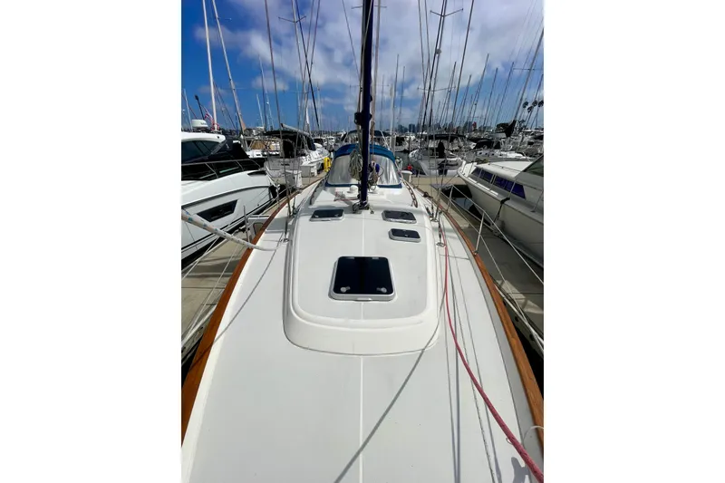 Slide: The Image of Sailboat Moody 42 CC 2000 model docked at marina under blue sky. - 63
