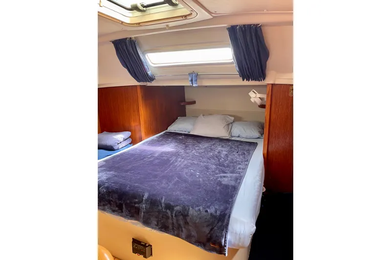 Slide: The Image of Cozy cabin interior of 2000 Moody 42 CC sailboat with bed and porthole. - 7