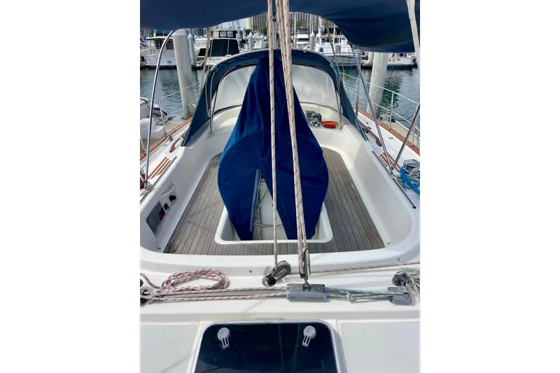Slide: The Image of Sailboat cockpit of 2000 Moody 42 CC, featuring blue covers and wooden deck. - 71
