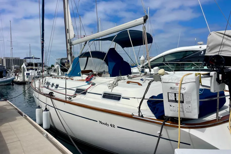 Slide: The Image of Sailboat Moody 42 CC, 2000 model, docked at marina under blue sky. - 77