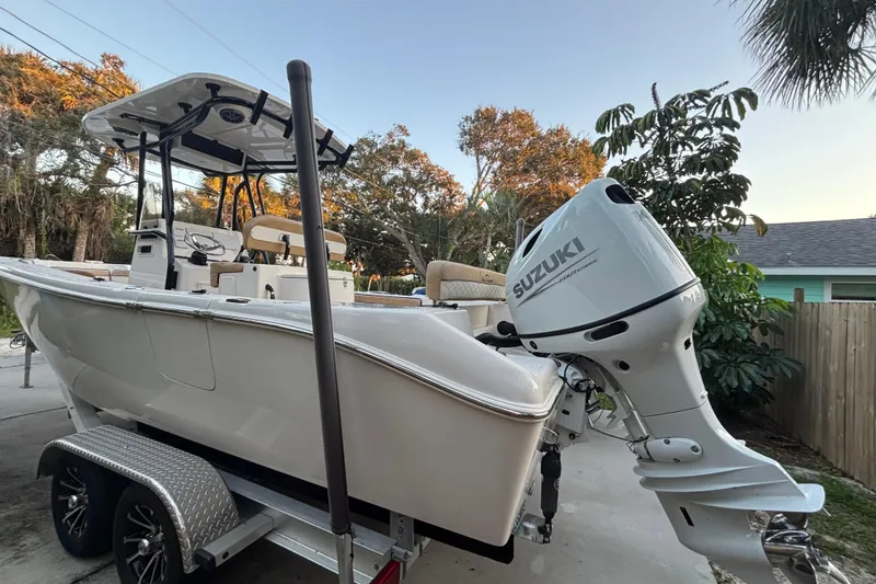 The Image of 2024 Sea Chaser 24 HFC boat on trailer, parked outdoors with palm trees. - 0