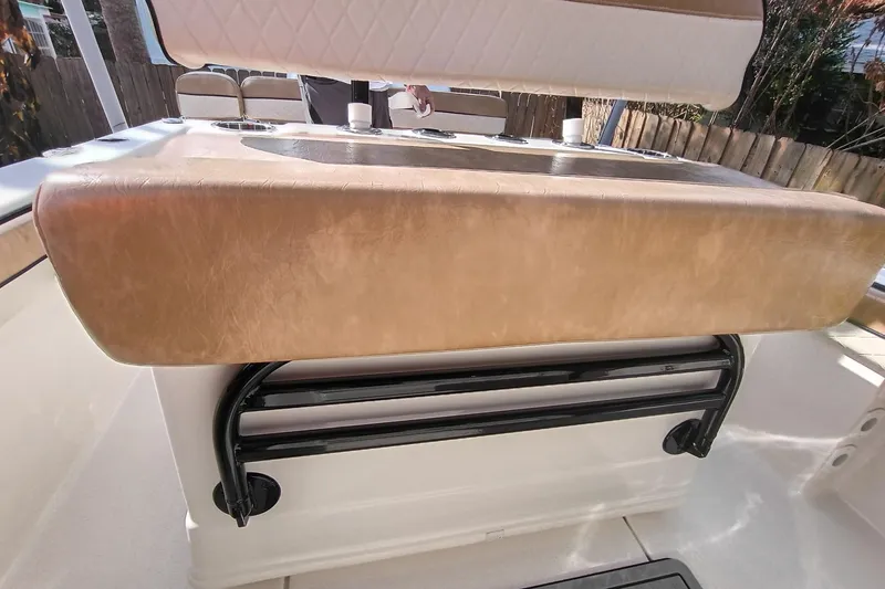 Slide: The Image of 2024 Sea Chaser 24 HFC boat interior with cushioned seating and storage. - 17