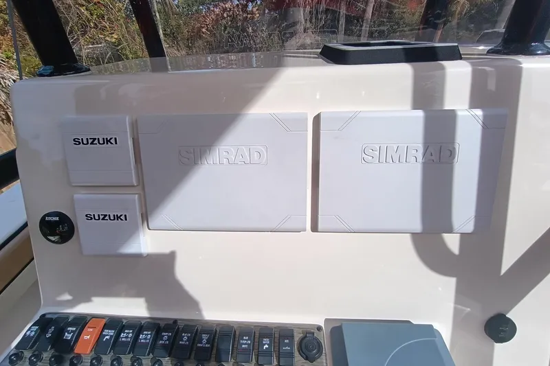 Slide: The Image of 2024 Sea Chaser 24 HFC dashboard with Suzuki and Simrad equipment. - 23