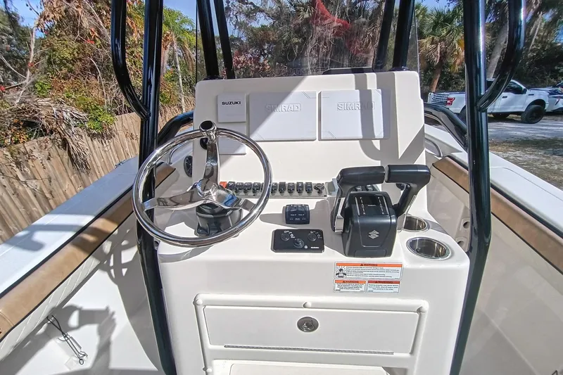 Slide: The Image of 2024 Sea Chaser 24 HFC boat console with steering wheel and controls. - 25