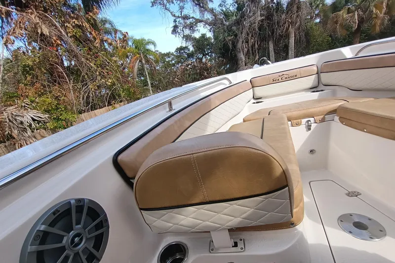 Slide: The Image of 2024 Sea Chaser 24 HFC boat interior with tan seating and speaker system. - 30