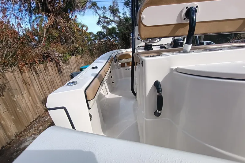 Slide: The Image of 2024 Sea Chaser 24 HFC boat interior with seating and console, outdoor setting. - 33