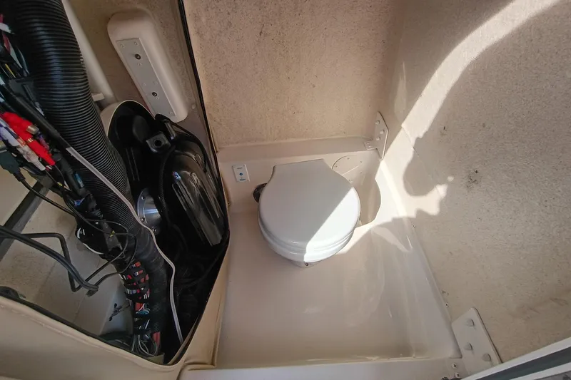 Slide: The Image of 2024 Sea Chaser 24 HFC boat interior with compact marine toilet and wiring. - 36