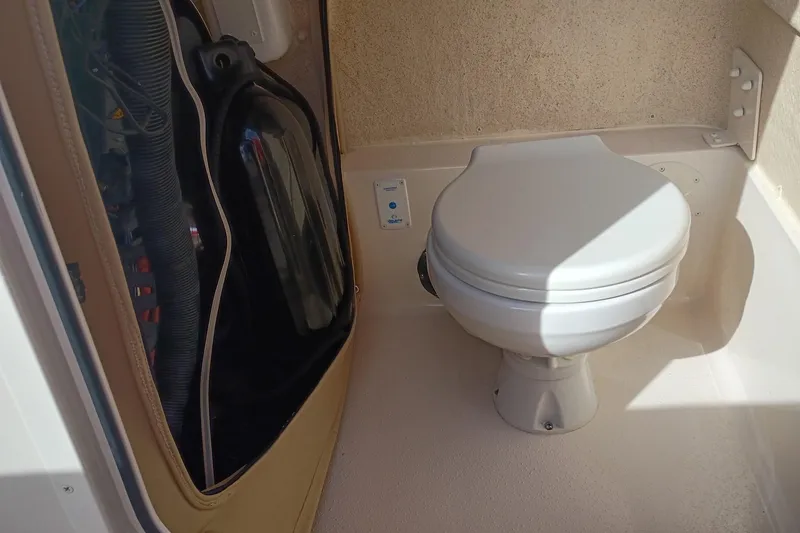 Slide: The Image of 2024 Sea Chaser 24 HFC boat interior with compact marine toilet. - 37