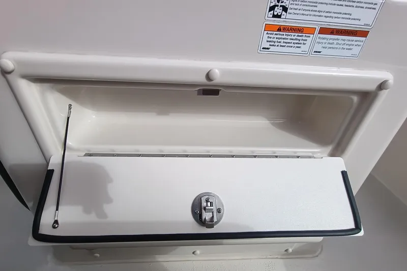 Slide: The Image of 2024 Sea Chaser 24 HFC boat storage compartment with black tinted cover and secure latches. - 40