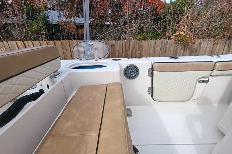 Slide: The Image of 2024 Sea Chaser 24 HFC storage compartment with safety warnings and latch. - 41