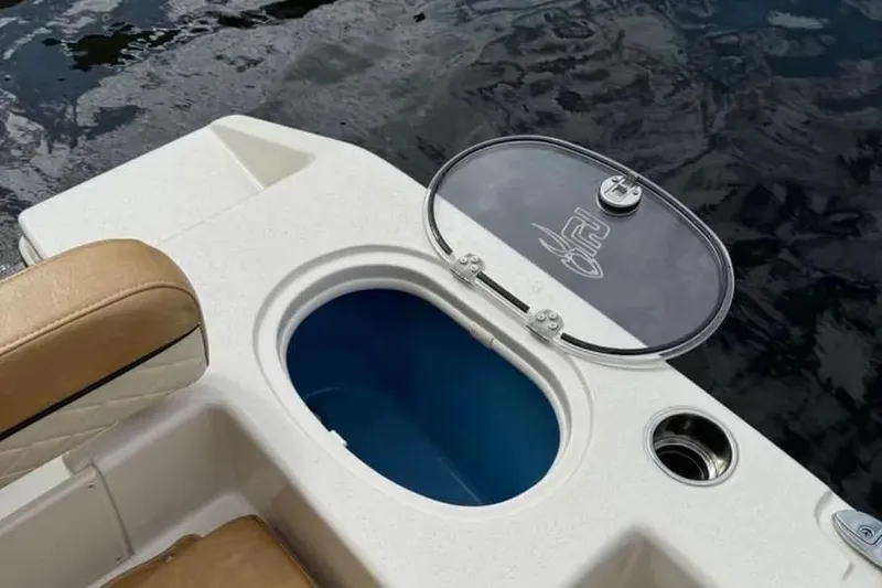 Slide: The Image of 2024 Sea Chaser 24 HFC boat with dual Suzuki outboard engines, parked outdoors. - 5