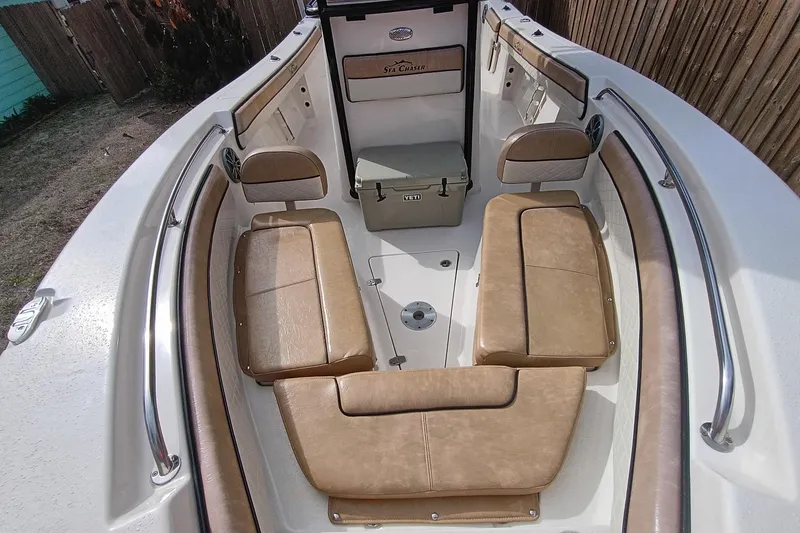 Slide: The Image of 2024 Sea Chaser 24 HFC boat interior with tan seating and Yeti cooler. - 50